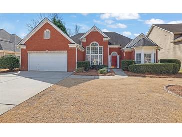 Charming red brick home featuring an attached two-car garage and a well-manicured front yard at 4198 Haynes Mill Nw Ct, Kennesaw, GA 30144