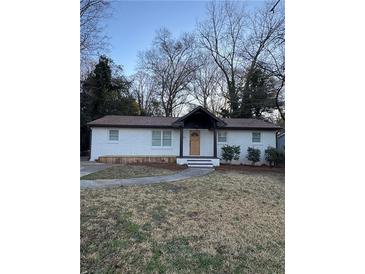 Charming single-story home featuring a brick facade and a well-manicured front yard at 3133 Rebecca St, Covington, GA 30014