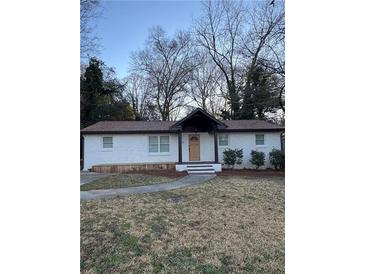 Charming, freshly painted home with a well-manicured front yard and inviting walkway at 3133 Rebecca St, Covington, GA 30014