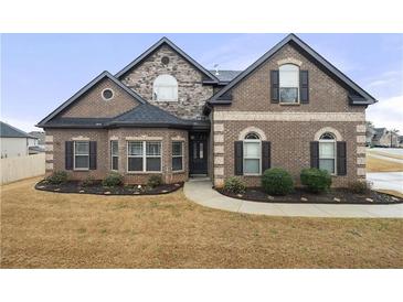 Charming brick home showcasing a manicured lawn and attractive landscaping for a welcoming curb appeal at 3492 Maple Hill Rd, Lithonia, GA 30038