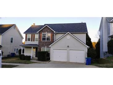 Charming two-story home featuring a two-car garage and a mix of siding and stone facade at 4728 Sedum Way, Atlanta, GA 30349