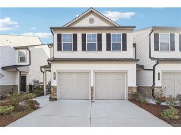 Charming townhome featuring a two-car garage, white siding, and black shutters, offering modern curb appeal at 3545 Bexton Dr, Duluth, GA 30097