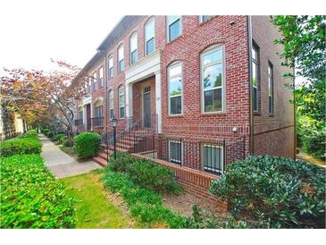 Charming brick townhome with manicured landscaping and a welcoming front entrance at 2428 Crescent Park Ct, Atlanta, GA 30339