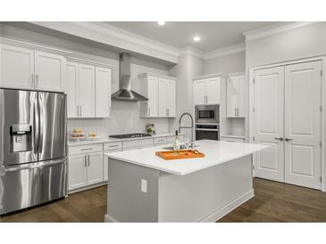Modern kitchen featuring white cabinets, stainless steel appliances, and a large center island at 685 Stickley Oak Way, Woodstock, GA 30189