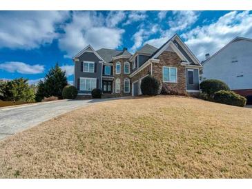 Beautiful two-story home with a combination of stone and siding, complemented by a well-manicured lawn at 1205 Trey Ct, Marietta, GA 30064