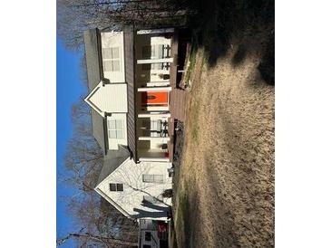 Charming two-story home featuring a welcoming front porch and an eye-catching orange front door at 281 Timber Laurel Ln, Lawrenceville, GA 30043