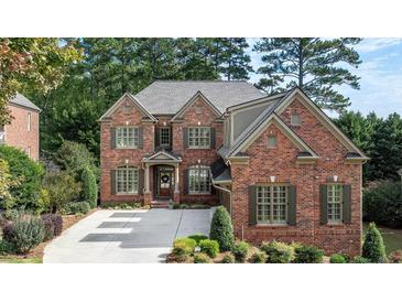 Beautiful two-story brick home with manicured lawn and mature trees in a quiet neighborhood at 1734 Doonbeg Ct, Kennesaw, GA 30152