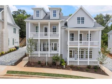 Charming two-story home with a double front porch and beautiful exterior paint at 2140 Parkside Ln, Roswell, GA 30076