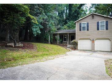 Charming two-story home with a well-manicured lawn and a two-car garage at 3938 Landress Way, Lawrenceville, GA 30044