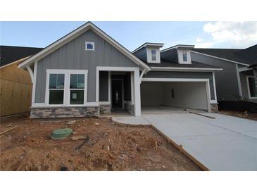Charming new construction home with gray siding, stone accents, and attached two-car garage at 2040 Ripple Park Bnd, Canton, GA 30114