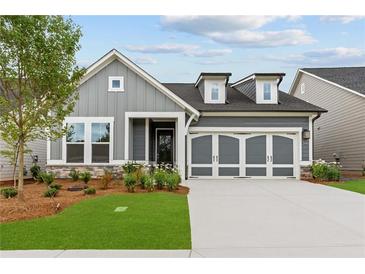 Charming single-Gathering home with a two-car garage, manicured lawn, and stone accents at 2040 Ripple Park Bnd, Canton, GA 30114