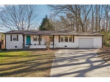 Charming single-story home with a well-manicured lawn and an attached one car garage at 2283 Noahs Ark Rd, Jonesboro, GA 30236