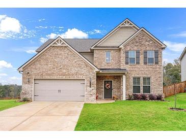 Charming two-story brick home with a well-manicured lawn and an attached two-car garage in a suburban setting at 4758 Sultana Way, Atlanta, GA 30331