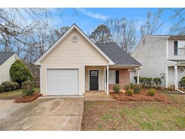 Charming single-story home with attached garage and well-maintained front yard landscaping at 132 Prity Ct, Mcdonough, GA 30253