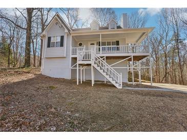 Charming home featuring a welcoming front porch and light gray exterior at 100 Nottingham Dr, Douglasville, GA 30134