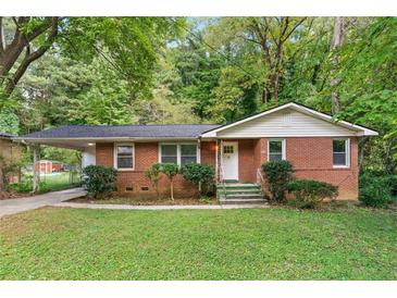 Charming brick home with a well-maintained lawn and mature trees, offering a cozy and inviting curb appeal at 2150 Meadowlane Dr, Atlanta, GA 30311