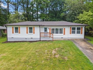 Charming, renovated single-story home featuring a well-manicured lawn and welcoming front porch at 2478 Graywall St, Atlanta, GA 30344