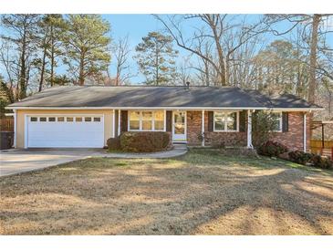 Charming one-story brick home with an attached garage and well-maintained front lawn at 767 Smithstone Se Rd, Marietta, GA 30067