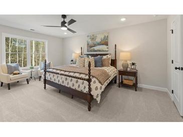 Charming bedroom featuring a four-poster bed, serene decor, and ample natural light from a large window at 4525 Twinberry Dr, Powder Springs, GA 30127