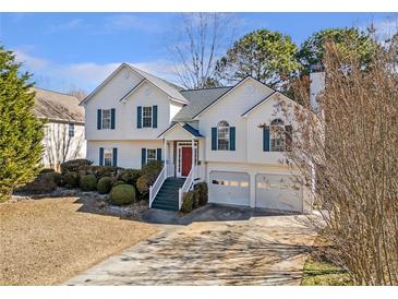 Charming two-story home with a well-manicured lawn and inviting curb appeal at 239 Taylors Farm Dr, Canton, GA 30115