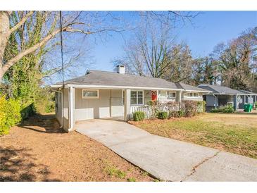 Charming one-story home featuring a covered entrance, grey paint, and a well-maintained front yard at 3449 Hyland Dr, Decatur, GA 30032