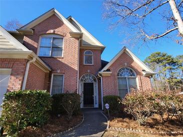 Charming two-story brick home featuring well-maintained landscaping and welcoming entrance at 4584 Madison Place Ln, Atlanta, GA 30360