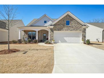 Charming single-Gathering home featuring a stone facade, two-car garage, and a cozy front porch at 2764 Bateman Sw St, Powder Springs, GA 30127
