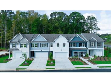 Charming townhomes feature varied color schemes, attached garages, and professionally landscaped yards at 541 Tuskegee St, Mcdonough, GA 30253