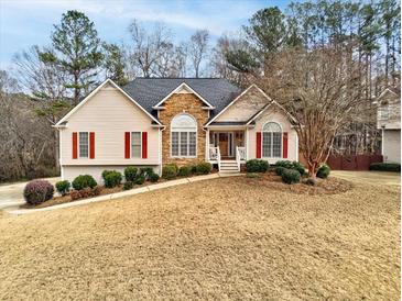 Charming single-Gathering home with a well-manicured lawn and inviting front porch at 764 Whitby Dr, Douglasville, GA 30134