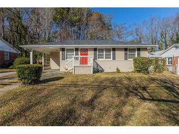 Charming ranch-style home featuring a bright red front door and a convenient covered carport at 858 Commodore Nw Dr, Atlanta, GA 30318