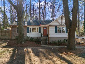 Charming single-Gathering home with cedar shingles, white siding, dark trim, and a welcoming red front door at 2746 Hedgewood Nw Dr, Atlanta, GA 30311