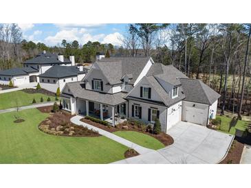 Stunning two-story home with a well-manicured lawn, a covered porch, and a three-car garage at 47 Cuthbert Ln Ne, Acworth, GA 30101