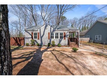 Charming home featuring a manicured lawn, inviting front porch, and freshly painted exterior at 1686 Terry Mill Se Rd, Atlanta, GA 30316