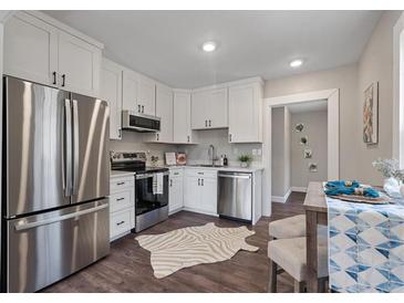 Bright kitchen features stainless appliances, white cabinets, and modern countertops at 1686 Terry Mill Se Rd, Atlanta, GA 30316