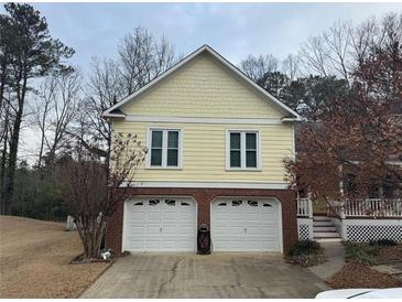 Two-story home featuring a brick-accented facade and a two-car garage at 3423 Conley Downs Drive, Powder Springs, GA 30127