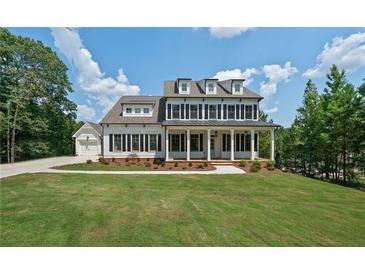 Elegant two-story home featuring a welcoming front porch and a well-manicured lawn at 112 Dallas Mark Drive, Canton, GA 30115