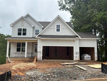 New construction home with a two-car garage with unfinished landscaping at 385 Riverwood Pass, Dallas, GA 30157