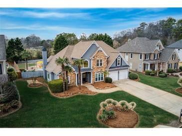 Stunning two-story home featuring a stone facade, well-manicured lawn, and a two-car garage at 820 Nob Ridge Dr, Marietta, GA 30064