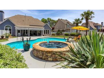 Stunning backyard featuring a sparkling pool and spa, perfect for relaxation and entertaining at 820 Nob Ridge Dr, Marietta, GA 30064