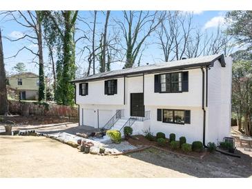 Charming two-story home featuring a freshly painted exterior, attached garage, and landscaped front yard at 3959 Emerald Springs Ct, Decatur, GA 30035