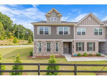 Charming townhome featuring stone accents, neutral siding, and well-maintained landscaping, creating a welcoming curb appeal at 6701 Cedar Glen Rd, Peachtree Corners, GA 30071