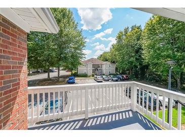 A balcony view overlooking a parking area and green space in a residential community at 1352 Orchard Park Dr, Stone Mountain, GA 30083