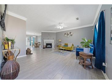 Spacious living room with fireplace, tile floors, and comfortable seating arrangement at 5099 Leeshire Trce, Tucker, GA 30084