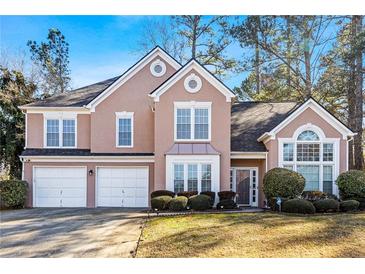Charming two-story home with a three-car garage and well-manicured landscaping at 1208 Lauren Nw Ct, Acworth, GA 30101
