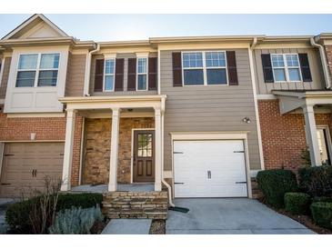 Charming townhome featuring stone accents, attached garages, and well-maintained landscaping at 2715 Maple Park Pl # 30, Cumming, GA 30041