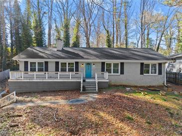 Charming single-story home with a welcoming front porch and a beautifully landscaped front yard at 2790 Collier Nw Dr, Atlanta, GA 30318