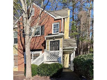 Charming townhome with a brick facade, inviting entryway, and well-maintained landscaping at 3015 Camden Way, Alpharetta, GA 30005