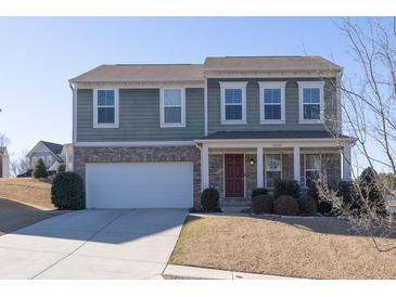 Charming two-story home with brick and siding exterior, showcasing a well-maintained front yard and attached two car garage at 1530 Avalon Creek Rd, Sugar Hill, GA 30518