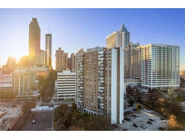 View of a high-rise building with a city skyline and bright sunshine at 215 Piedmont Ne Ave # 1608, Atlanta, GA 30308