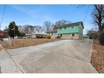 Charming two-story home with a spacious front yard and long driveway at 6100 Prestige Valley Rd, Morrow, GA 30260